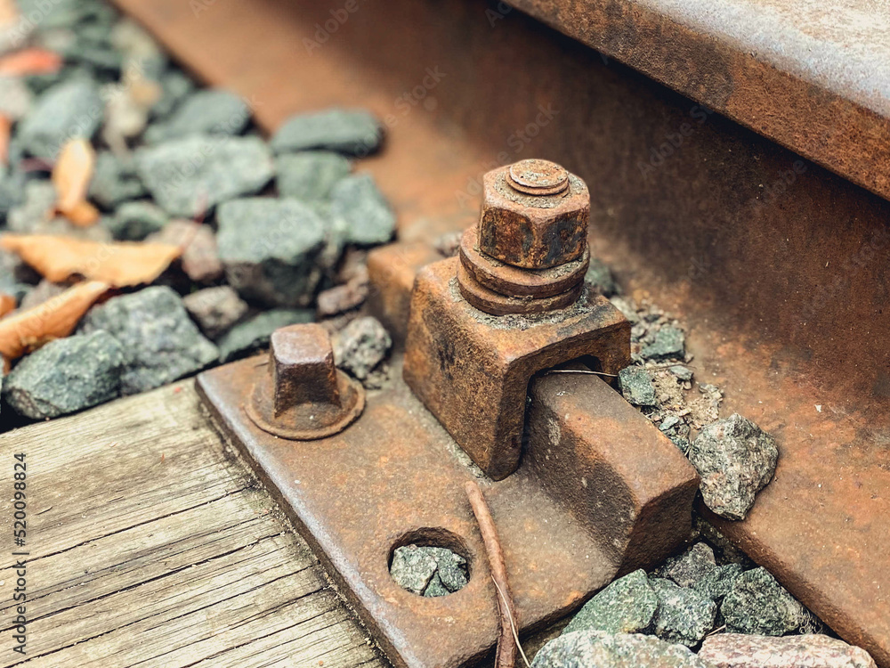 old, abandoned railroad. the rails are fixed with strong metal bolts to the ground. rusty structure for the passage of trains on the road old, abandoned railroad. the rails are fixed with strong metal bolts to the ground. rusty structure for the passage of trains on the road