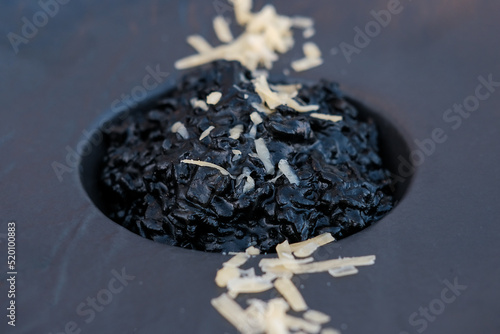 Delicious Italian seafood risotto with cuttlefish ink- squid ink. Black risotto. Healthy luxury food.