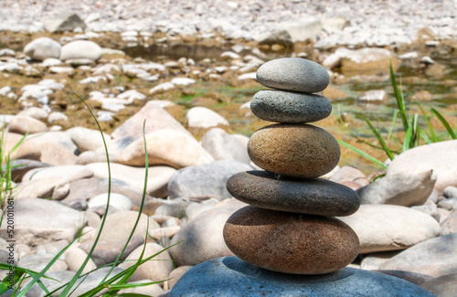 Stone balancing with pebble tower on a river rocky beach