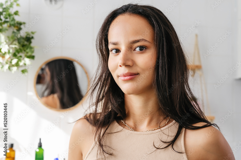 Close up beauty portrait of mixed-race woman in bathroom. Confident young woman feeling positive and comfortable in her body. Wellness and body positivity Close up beauty portrait of mixed-race woman in bathroom. Confident young woman feeling positive and comfortable in her body. Wellness and body positivity