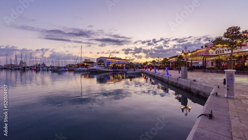 Beautiful Marina, Limassol city Cyprus. Modern, high end life in newly developed port with docked yachts, restaurants, shops, a landmark for waterfront promenade. View of the commercial area at sunset