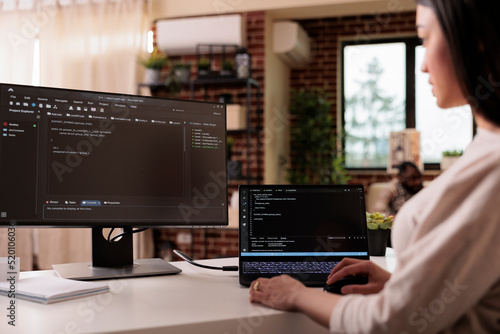 Female freelance developer coding html script with online cloud server and programming firewall security. Learning new user interface on terminal window with code language and application.
