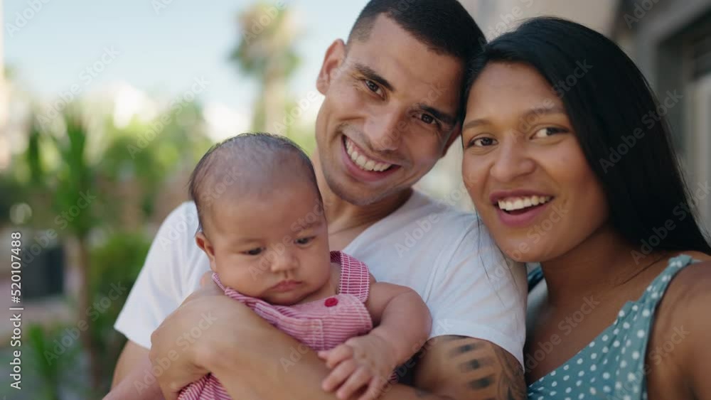 Hispanic family smiling confident hugging each other speaking at street Hispanic family smiling confident hugging each other speaking at street
