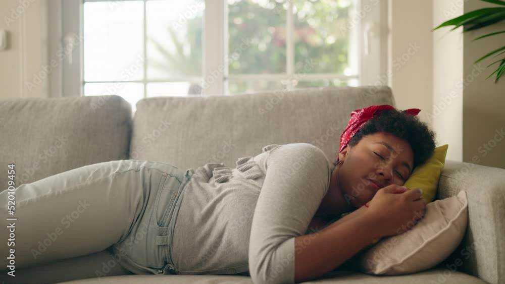 African american woman smiling confident lying on sofa at home African american woman smiling confident lying on sofa at home