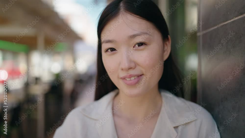 Chinese woman smiling confident standing at street Chinese woman smiling confident standing at street