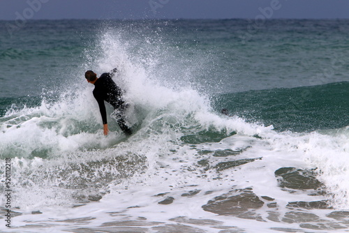 Surfing on high waves in the Mediterranean.