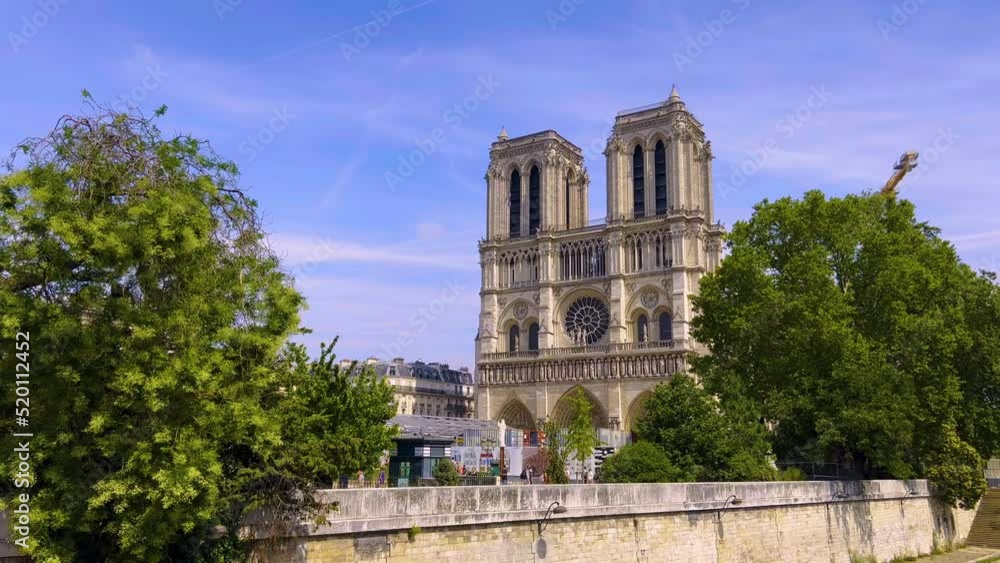 Paris, France, 28 July 2022 : Notre-Dame de Paris cathedral under construction and renovation after the fire. Nice day footage of the Notre dame facade Paris, France, 28 July 2022 : Notre-Dame de Paris cathedral under construction and renovation after the fire. Nice day footage of the Notre dame facade