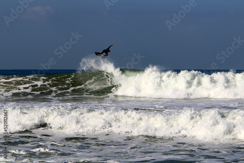 Surfing on high waves in the Mediterranean.