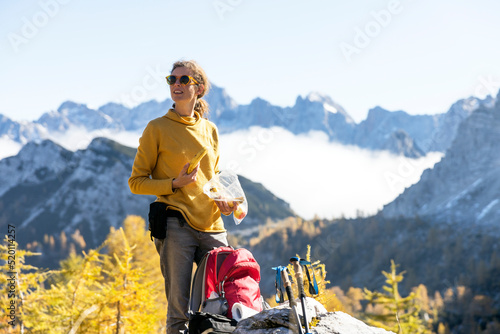 Meal Break for a Serene Woman Hiker in Autumn European Alps - Slemenova Spica Julian Alps Slovenia photo