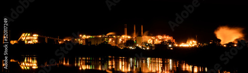 Panorama of an alumina refinery in Gladstone  Queensland  at night time with reflected lights.