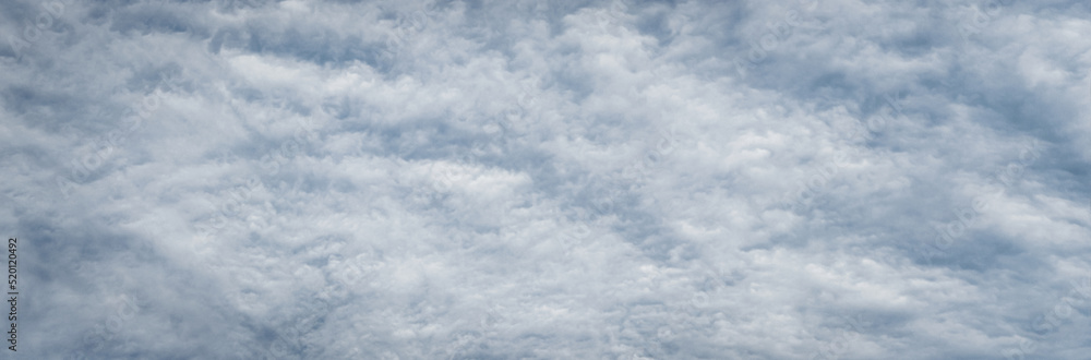 Fototapeta premium Fleecy clouds texture, cloudy sky background, wide banner size gray cloudscape