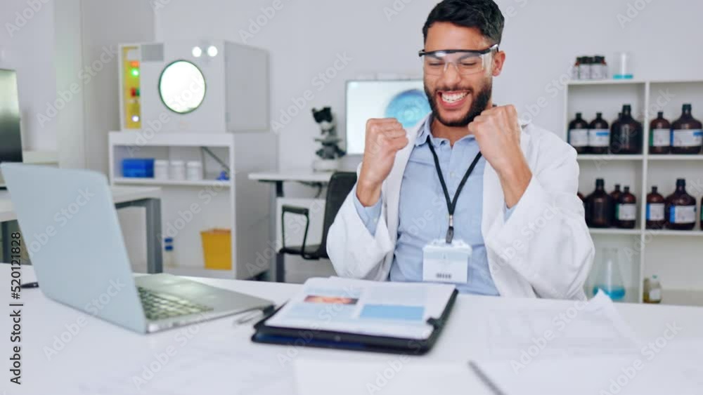 Success, innovation and modern science, health care professional celebrate good news while reading on laptop in research room. Male scientist expressing joy while discovery of a breakthrough or cure Success, innovation and modern science, health care professional celebrate good news while reading on laptop in research room. Male scientist expressing joy while discovery of a breakthrough or cure