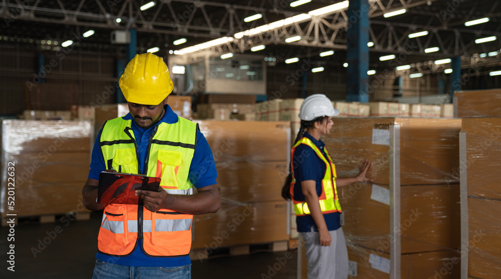 Portrait of staff worker standing in warehouse with his arm crossed looking at camera. Portrait of staff worker standing in warehouse with his arm crossed looking at camera.