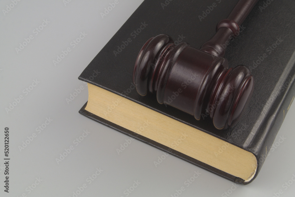 Wooden judge gavel on legal book on gray background 