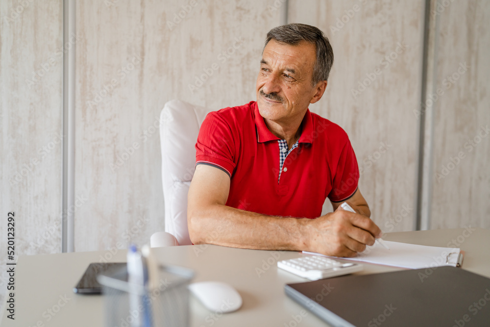 senior caucasian man working at the desk table at the office or home senior caucasian man working at the desk table at the office or home