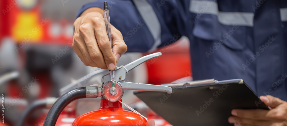 Fototapeta premium Engineer are checking and inspection a fire extinguishers tank in the fire control room for safety training and fire prevention.