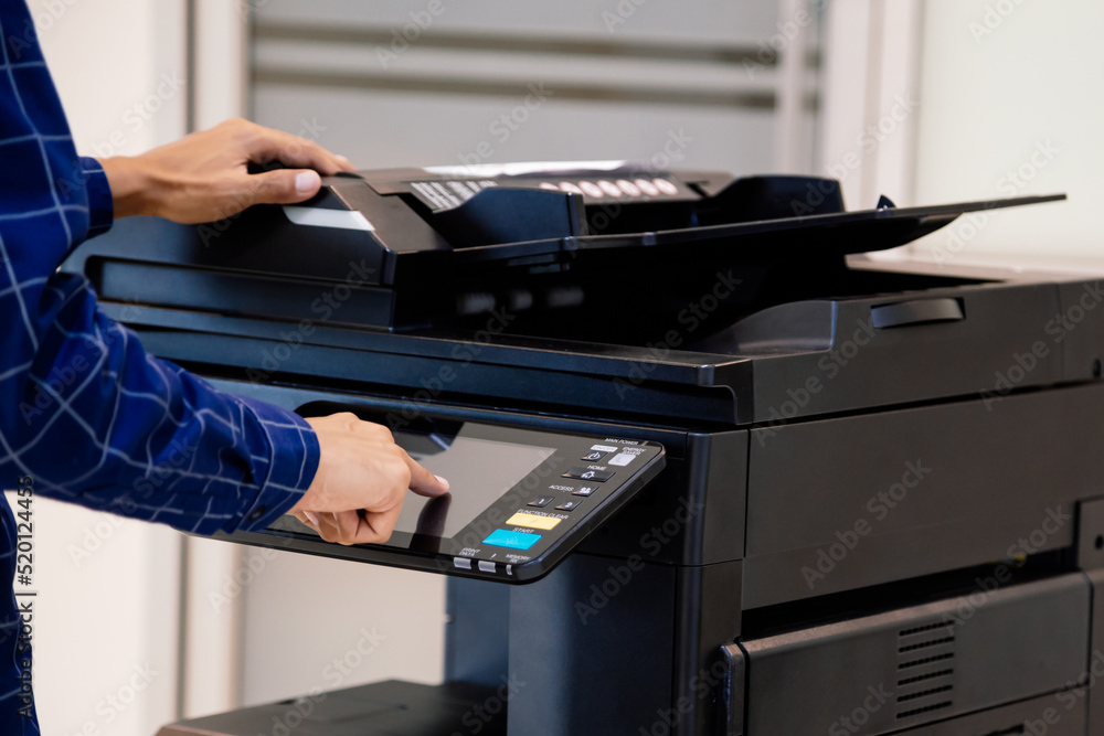 Businessmen press button on the panel for using photocopier or printer for printout and scanning document paper at office. Businessmen press button on the panel for using photocopier or printer for printout and scanning document paper at office.