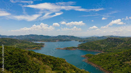 Fototapeta Naklejka Na Ścianę i Meble -  Aerial view of Mountains with rainforest and blue lake. Kalu Ganga Reservoir, Sri Lanka.