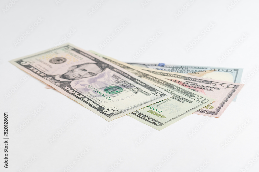 5, 20, 50, 100 dollars banknotes at different angles. Close up of dollars on white background. 5, 20, 50, 100 dollars banknotes at different angles. Close up of dollars on white background.