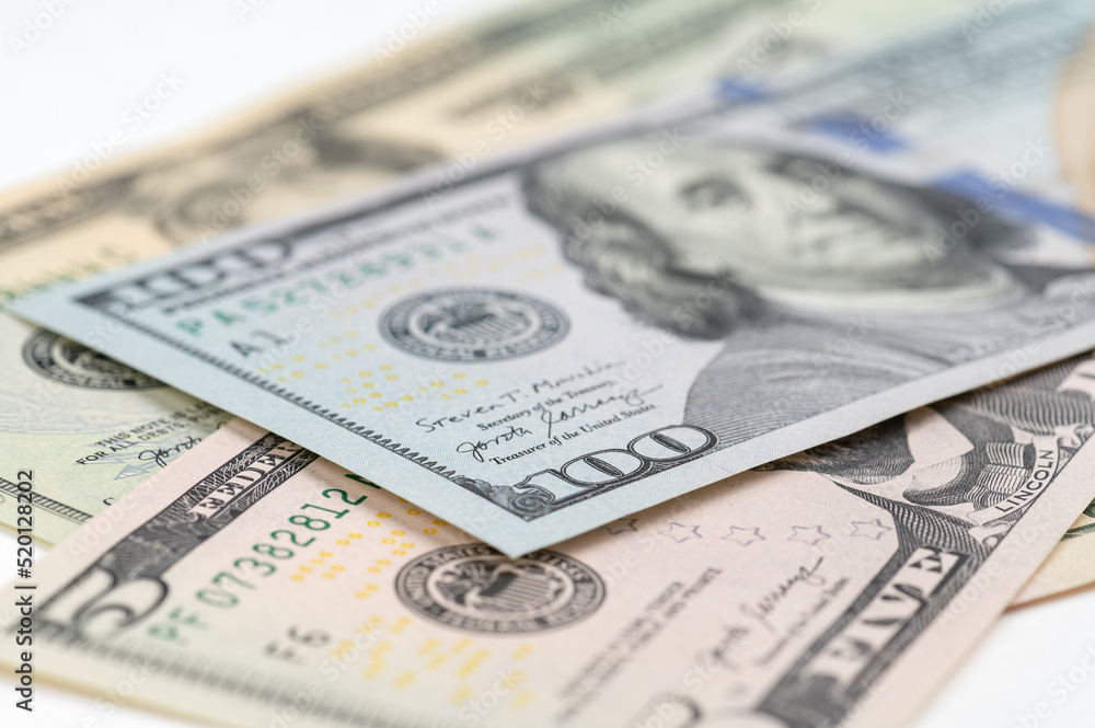 5, 20, 50, 100 dollars banknotes at different angles. Close up of dollars on white background. 5, 20, 50, 100 dollars banknotes at different angles. Close up of dollars on white background.