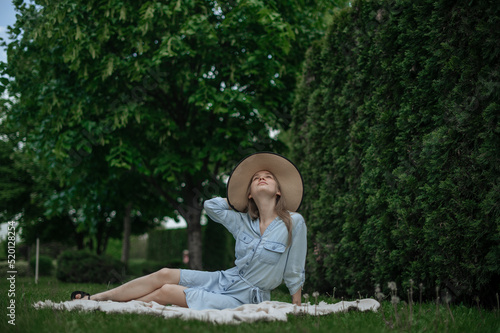 Romantic girl with hat on picnic in park