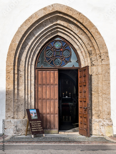 Old wooden door in a church is open for all nations