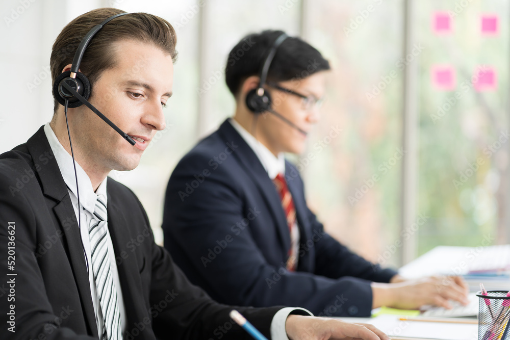 Group of customer service call center with headset and writing note to seek advice problems for customer. Group of technical support operator customer service in the office Group of customer service call center with headset and writing note to seek advice problems for customer. Group of technical support operator customer service in the office
