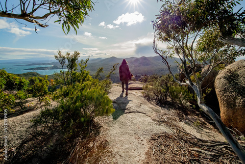super woman on a top of the mountain  at freycinet national park Tasmania Australia ( sleepy bay )