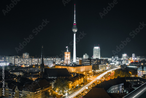 berlin alexanderplatz and tv tower night time hot with long exposure traffic lights with buildings and grey yellow colors scheme © Galactic Nikita