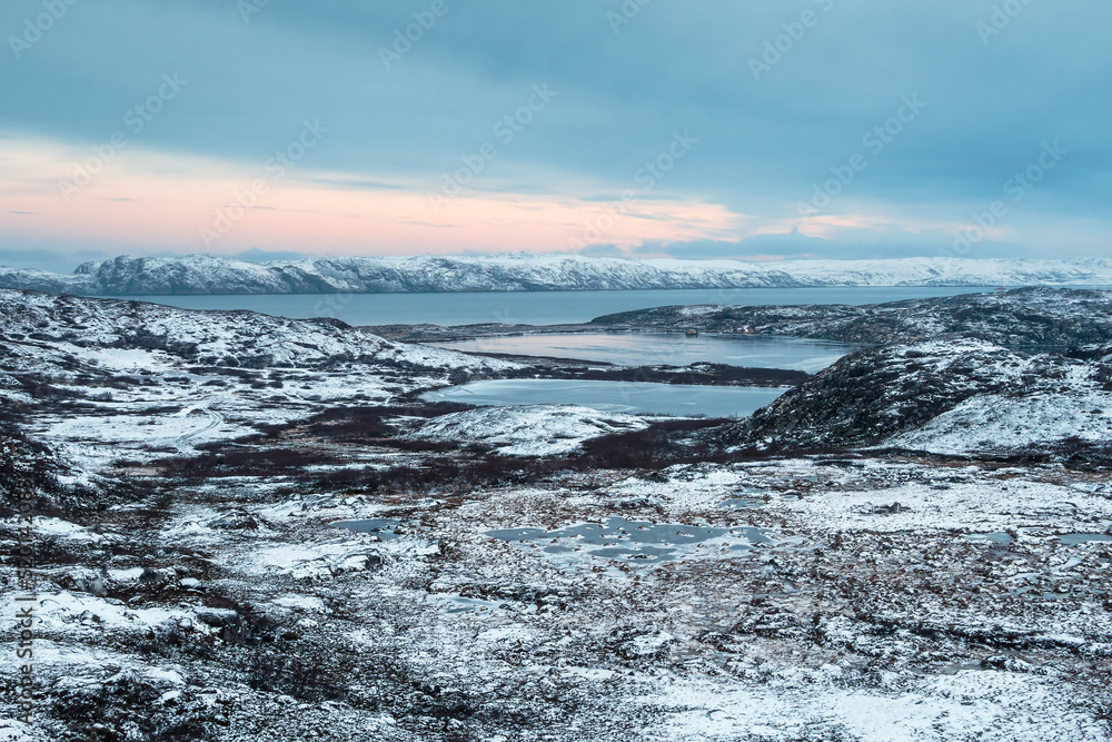 Harsh Arctic landscape. Frozen tundra with icy lakes at dawn. Amazing northern nature. Harsh Arctic landscape. Frozen tundra with icy lakes at dawn. Amazing northern nature.