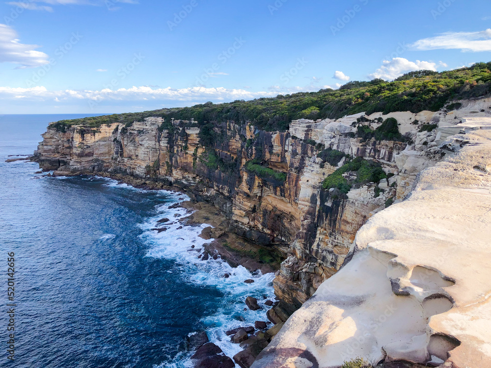 Obraz premium Long shot of the side of a cliff at an Australian National Park - hiking towards the Wedding Cake Rock.