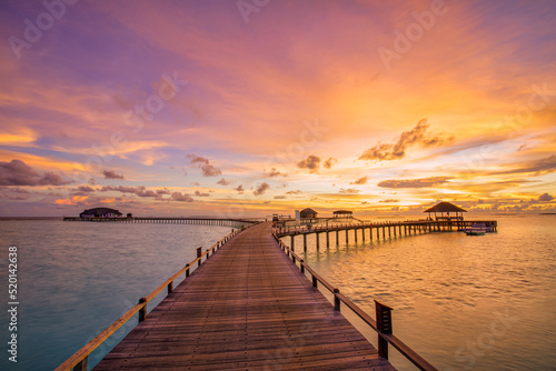 Amazing beach landscape. Beautiful Maldives sunset seascape view. Horizon colorful sea sky clouds  over water villa pier pathway. Tranquil island lagoon  tourism travel background. Exotic vacation