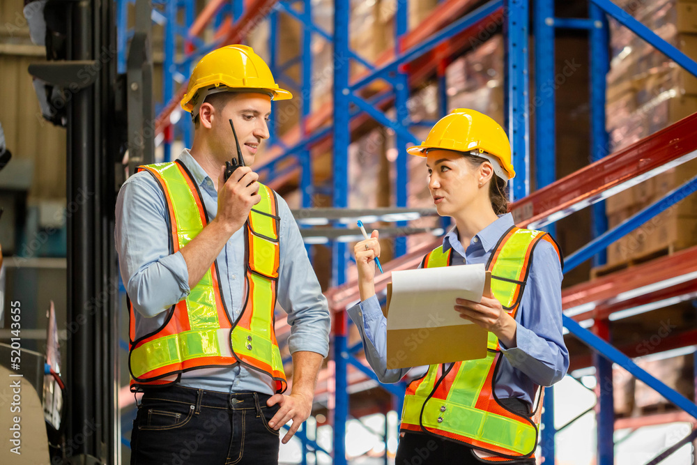 Workers working in warehouse, Manager and supervisor taking inventory in warehouse, Female foreperson making plans with warehousemen Workers working in warehouse, Manager and supervisor taking inventory in warehouse, Female foreperson making plans with warehousemen