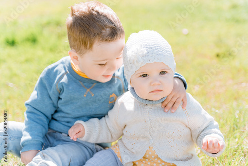 Konstfotografi A boy of three years old hugs his displeased little sister, children sit on the