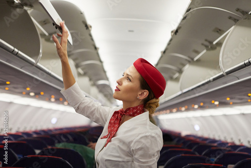 stewardess inspecting the cabin of a passenger liner after a flight photo