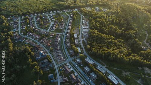 Small modern village in summer at sunset. Aerial view