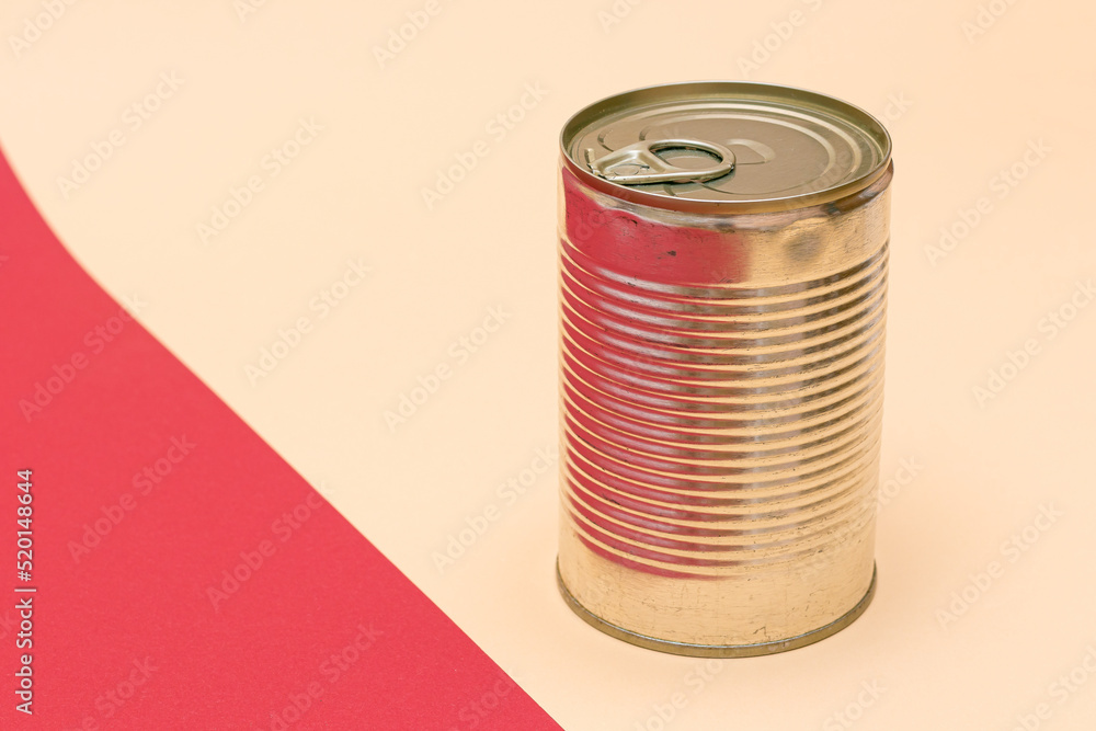 Unopened Tin Can with Blank Edge on Split Red and Beige Background. Canned Food. Aluminum Can for Safe and Long Term Storage of Food. Steel Sealed Food Storage Container Unopened Tin Can with Blank Edge on Split Red and Beige Background. Canned Food. Aluminum Can for Safe and Long Term Storage of Food. Steel Sealed Food Storage Container