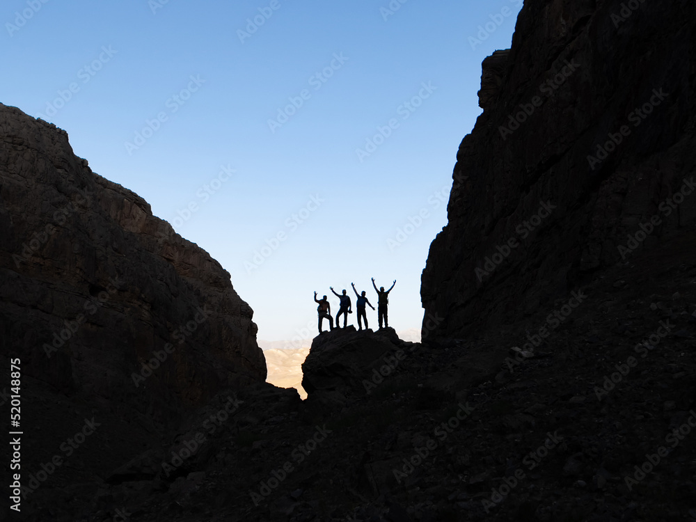 successful team of mountaineers among the big cliffs