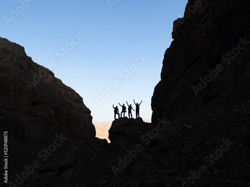 successful team of mountaineers among the big cliffs