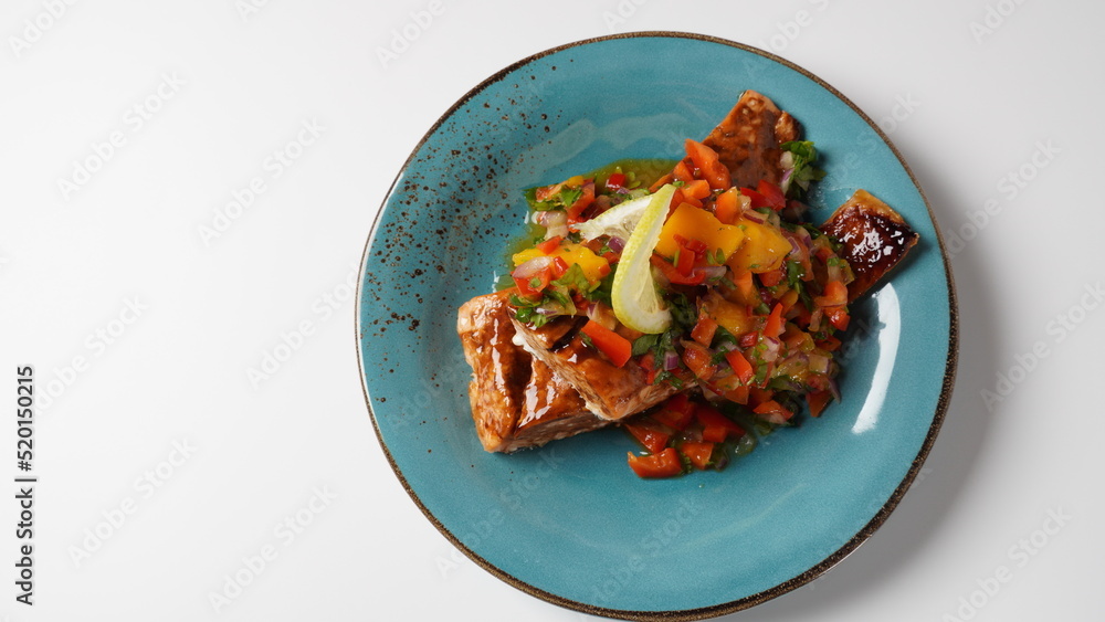 Glazed salmon fillet with mango salsa, herbs and lemon Glazed salmon fillet with mango salsa, herbs and lemon