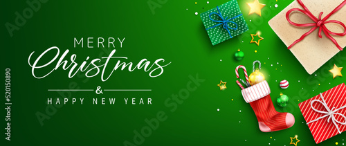 Christmas greeting vector design. Merry christmas greeting text in green space with gifts and sock stockings decoration element for xmas holiday messages. Vector illustration. 
