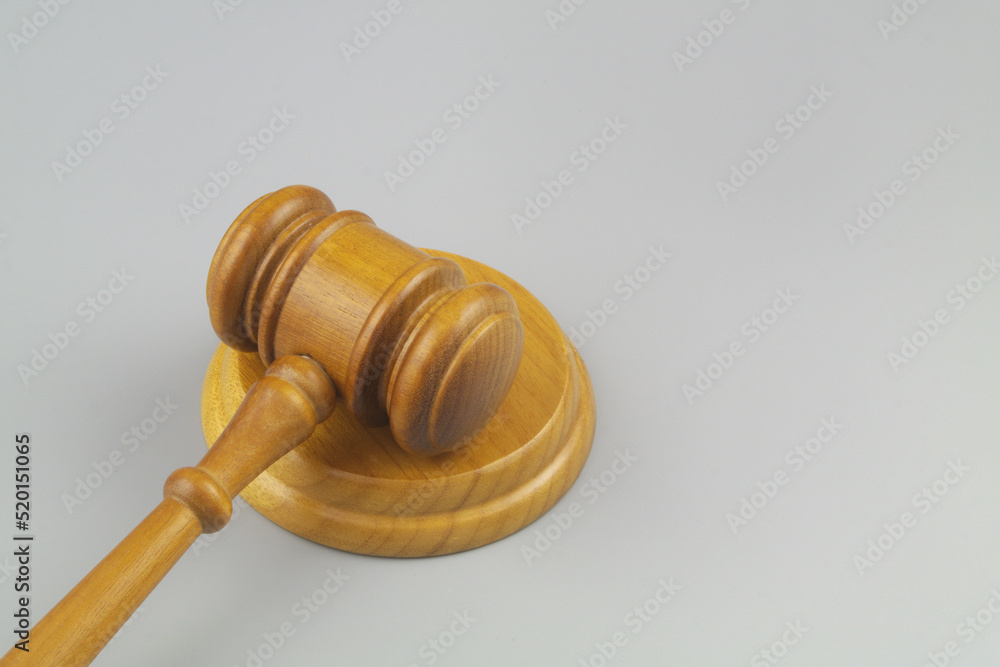 Wooden judge gavel on gray background close up. Laws, justice, court and legal system concept. Wooden judge gavel on gray background close up. Laws, justice, court and legal system concept.