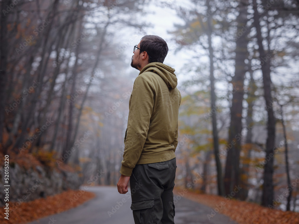 Young handsome man posing in autumn forest. Young handsome man posing in autumn forest.