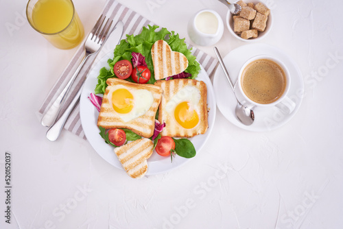 Heart shaped Fried Egg on Toast Bread and cup of fresh hot espresso coffee