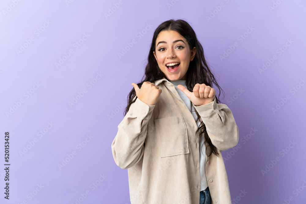 Young caucasian woman isolated on purple background pointing to the side to present a product Young caucasian woman isolated on purple background pointing to the side to present a product
