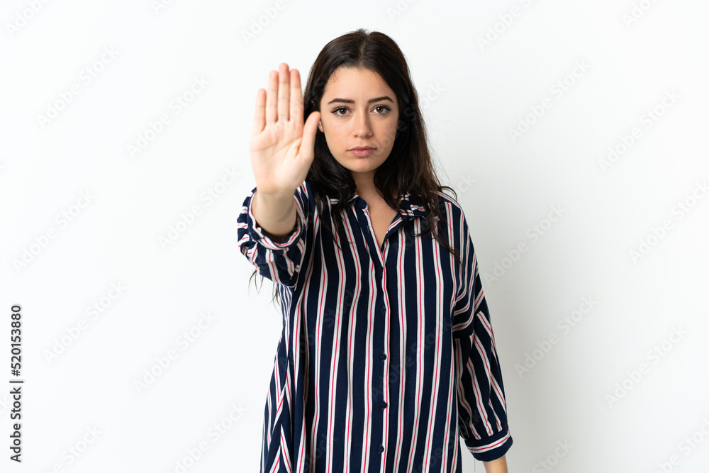 Young caucasian woman over isolated background making stop gesture Young caucasian woman over isolated background making stop gesture
