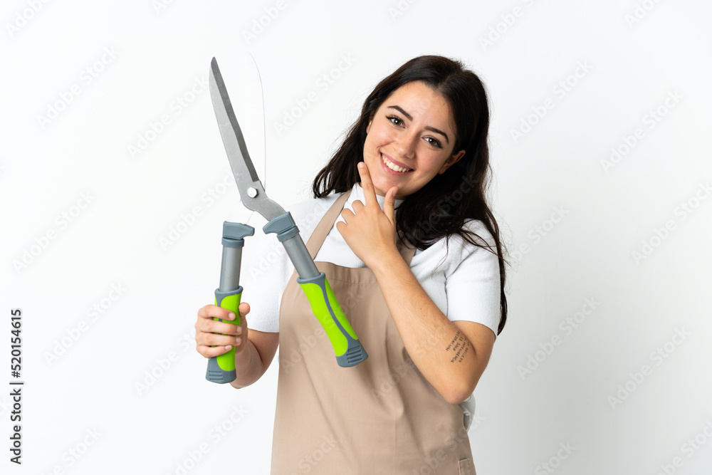Young caucasian woman holding a plant isolated on white background happy and smiling Young caucasian woman holding a plant isolated on white background happy and smiling
