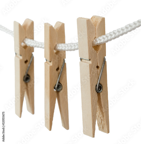 Den Helder, Netherlands. July 2022. Wooden clothes pegs on a white background. Selective focus.