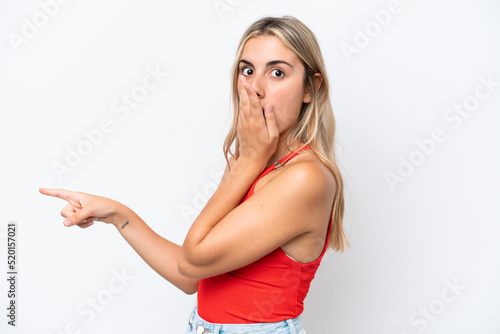 Young caucasian woman isolated on white background with surprise expression while pointing side