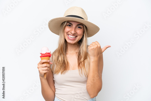Young caucasian woman with a cornet ice cream isolated on white background pointing to the side to present a product